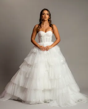 White wedding dress with a bushier top and a bushier puffy layered skirt