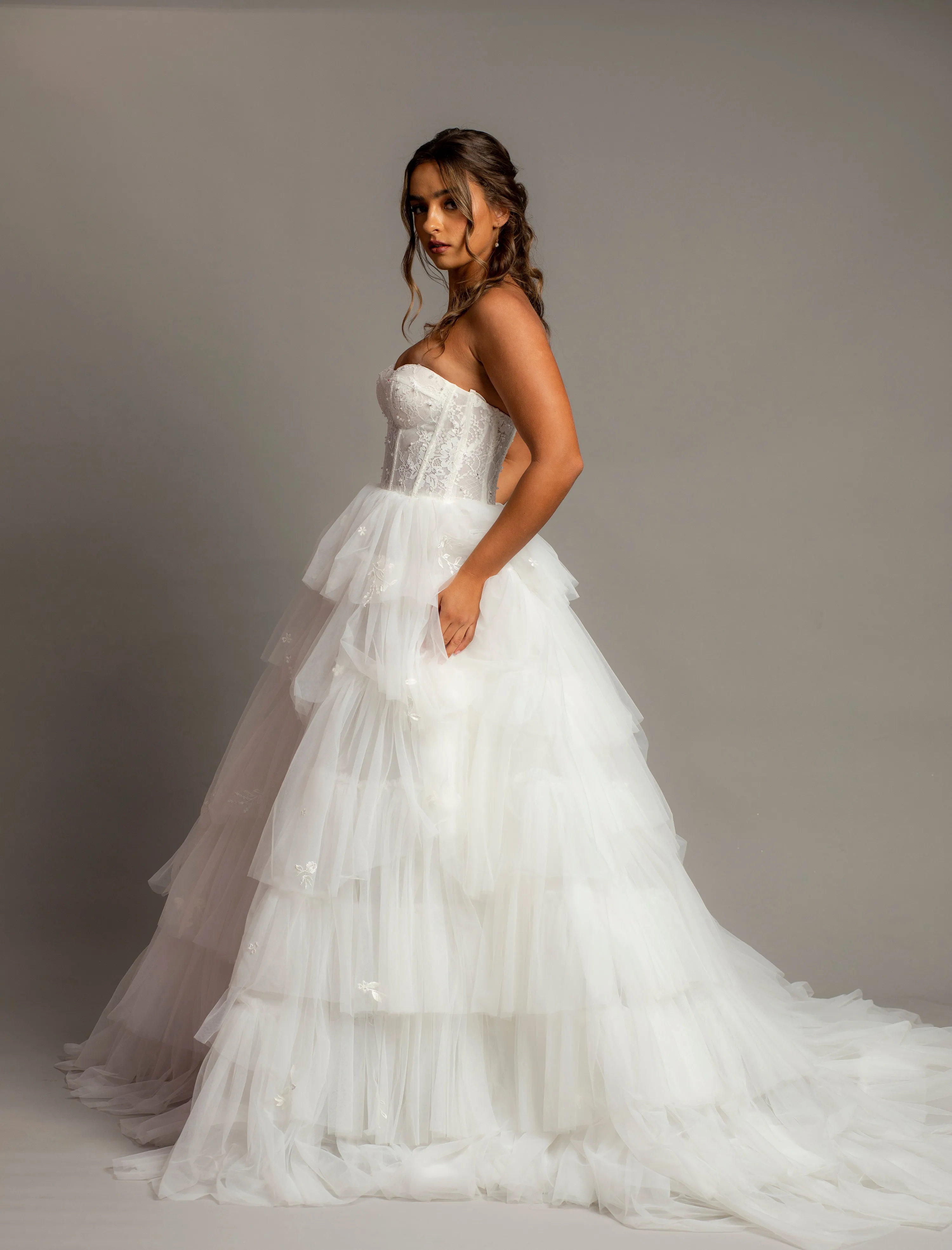 White wedding dress with a bushier top and a bushier puffy layered skirt