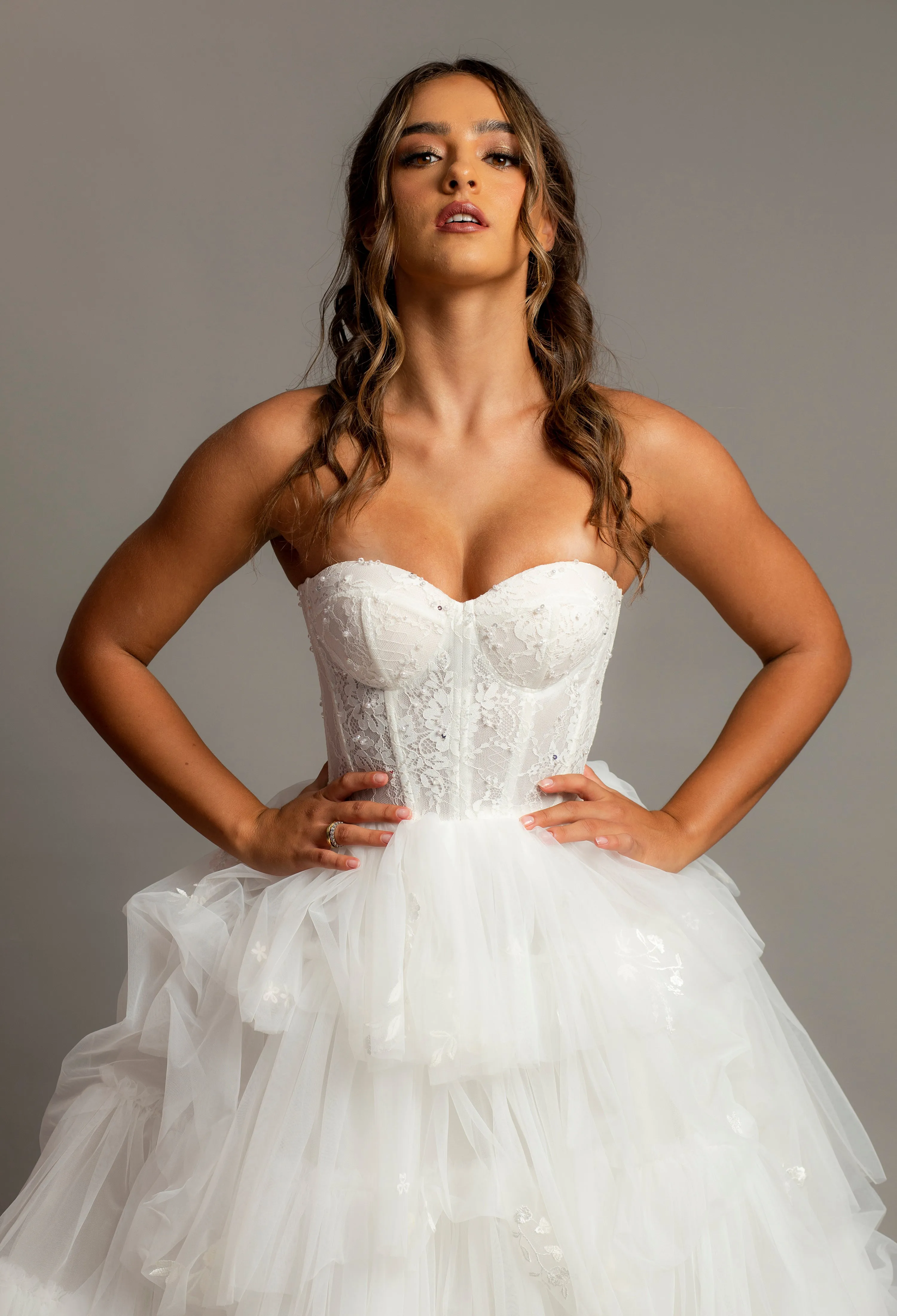 White wedding dress with a bushier top and a bushier puffy layered skirt