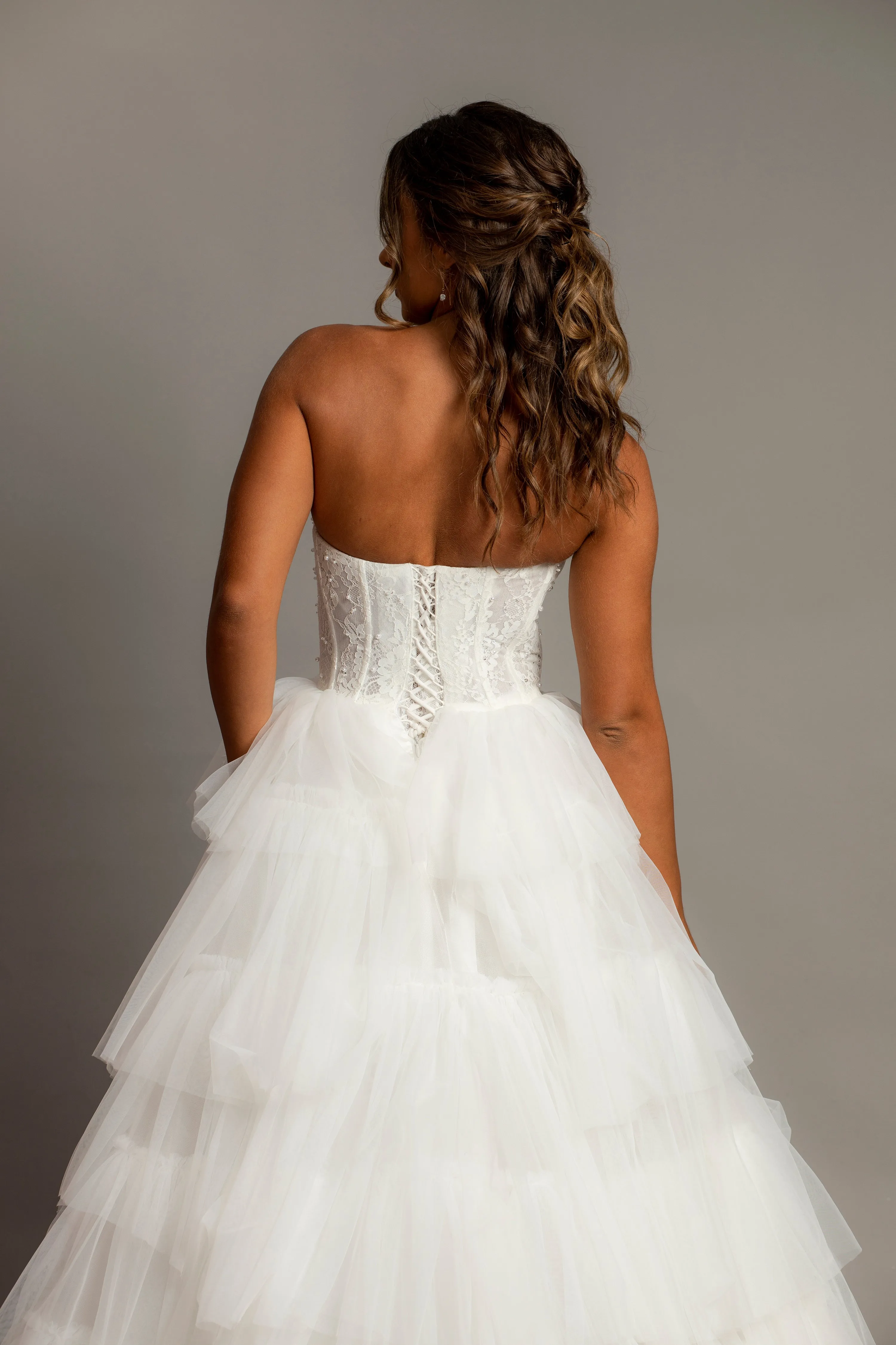 White wedding dress with a bushier top and a bushier puffy layered skirt