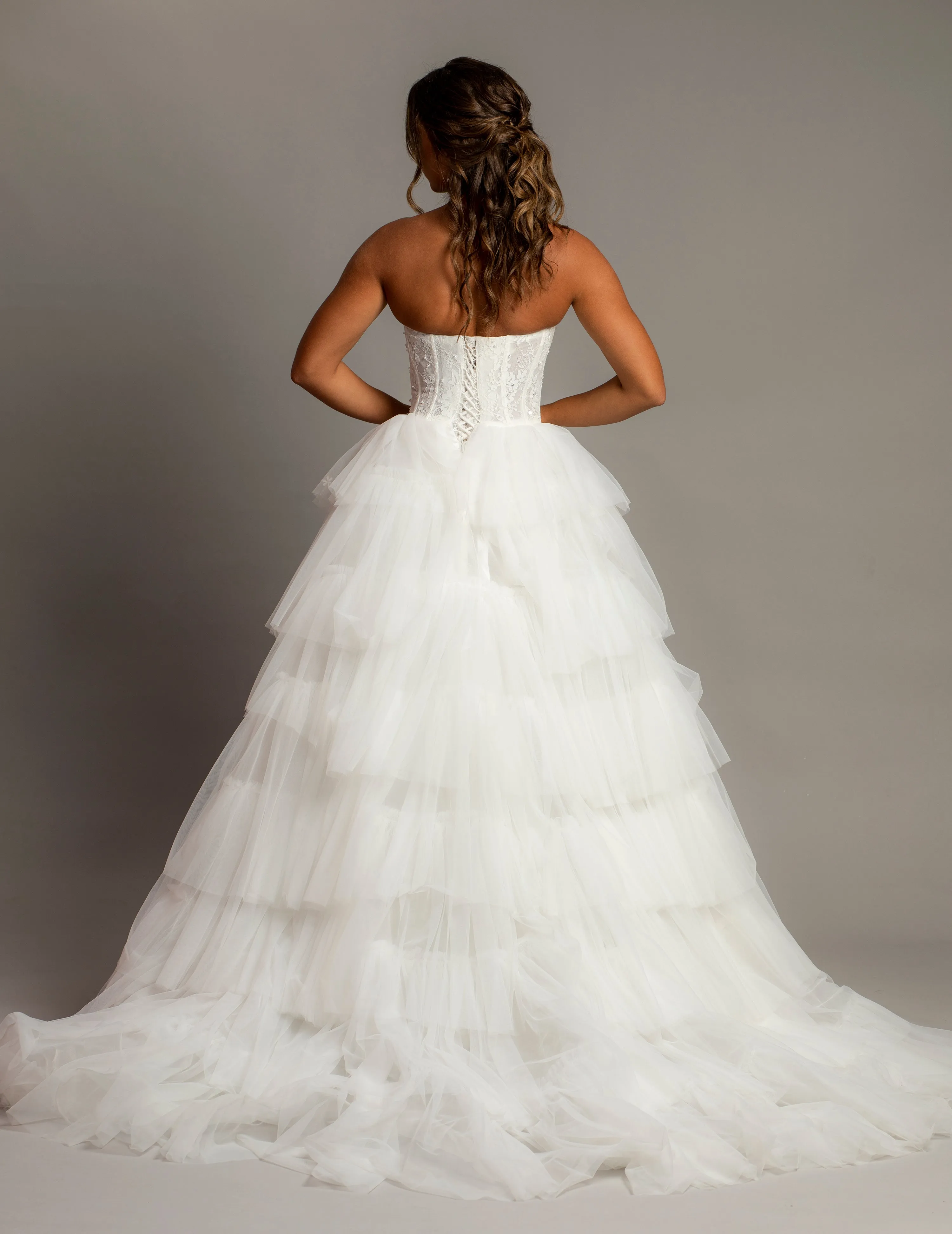 White wedding dress with a bushier top and a bushier puffy layered skirt