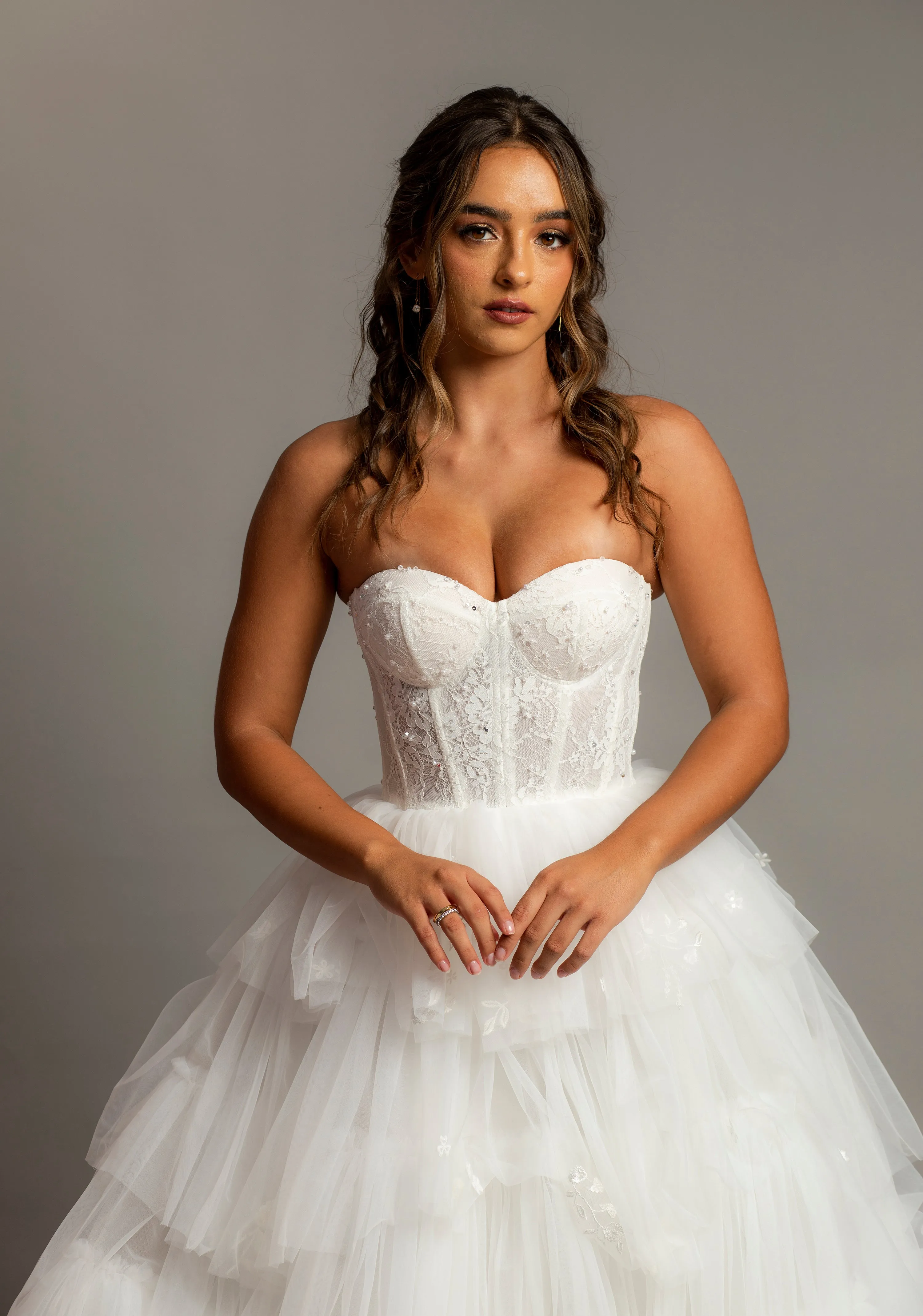 White wedding dress with a bushier top and a bushier puffy layered skirt